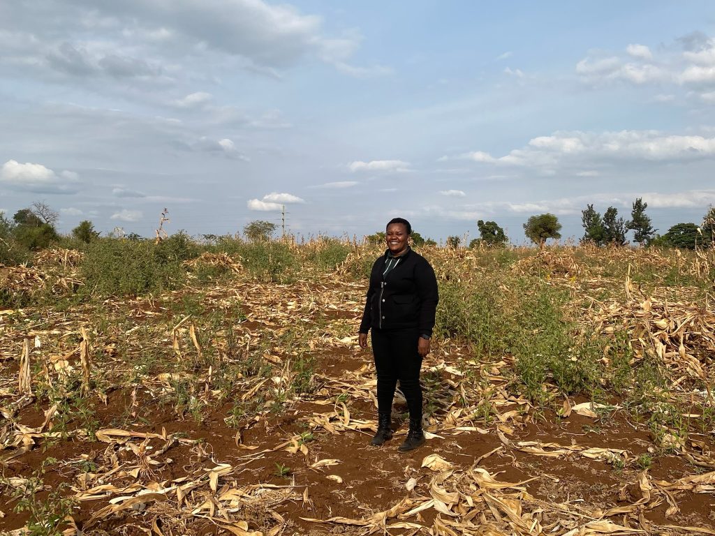 In the image, Penina, the founder, stands on the new plot designated for the daycare.